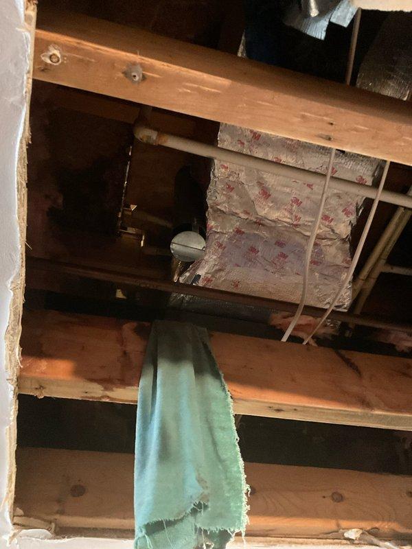 Conducted a comprehensive water heater replacement estimate for a unit installed in a recessed closet. Inspection revealed aging unit with standard connections to gas line and water pipes. Documented structural considerations including ceiling cavity access and existing insulation that would impact installation requirements. Recommended replacement with applicable discount coupon available.