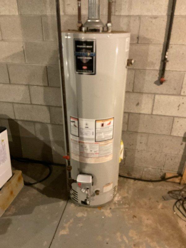 Conducted on-site assessment of existing water heater installation in unfinished basement. Unit is currently installed against concrete block wall with proper copper pipe connections and metal exhaust ventilation. Provided comprehensive estimate for replacement options based on current 40-gallon tank configuration and household needs (Quote #03548-01).