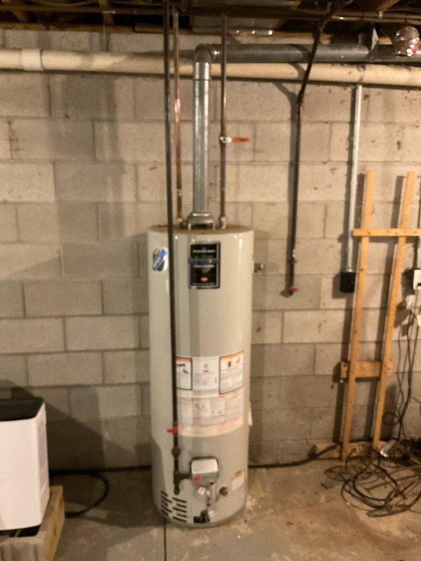 Conducted on-site assessment of existing water heater installation in unfinished basement. Unit is currently installed against concrete block wall with proper copper pipe connections and metal exhaust ventilation. Provided comprehensive estimate for replacement options based on current 40-gallon tank configuration and household needs (Quote #03548-01).