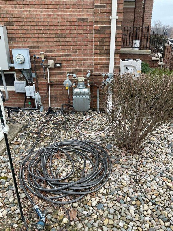Conducted site assessment for tankless water heater installation to replace existing tank model WH10-12. Evaluated current utility connections including gas line capacity, existing PVC venting configuration, and electrical service panel. Documented exterior gas meter and connection points to determine appropriate sizing for new tankless unit.