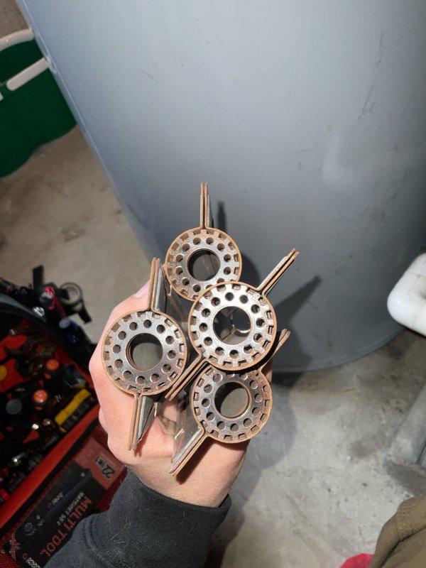 Performed scheduled maintenance on club Heat12-4 unit. Removed and inspected four corroded thermal expansion valve components with significant oxidation on the copper surfaces and mounting brackets. Documented condition with photos for replacement recommendation.