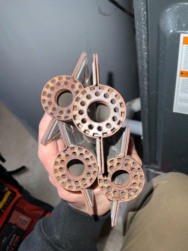 Performed scheduled maintenance on club Heat12-4 unit. Removed and inspected four corroded thermal expansion valve components with significant oxidation on the copper surfaces and mounting brackets. Documented condition with photos for replacement recommendation.