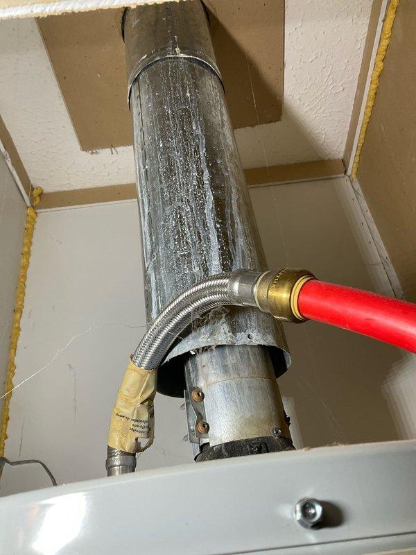 Diagnosed and replaced a malfunctioning tanked water heater that was producing inadequate heating and discharging gray-colored water. Installed new unit with proper connections to existing hot water line and PVC ventilation system, ensuring proper sealing at wall penetrations and verifying all fittings were secure with no leaks upon system restart.