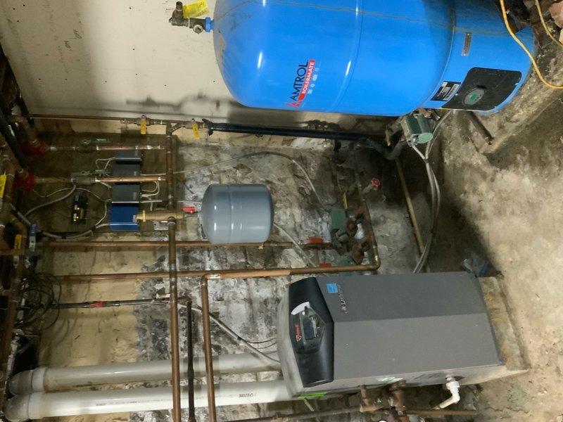 Responded to no-heat service call for boiler malfunction following recent power outage (reference #10-289). Inspection of the utility room revealed the Amtrol expansion tank and associated plumbing components were intact, but the boiler controller had reset to factory settings. Reprogrammed the control panel parameters, purged air from the system, and verified proper operation through a complete heating cycle.
