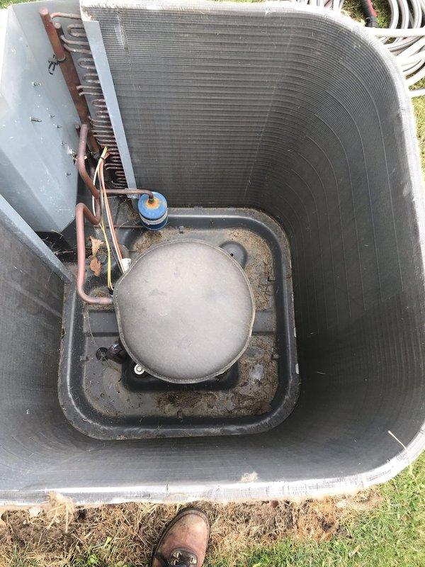 Conducted routine maintenance on Club AC12-4 unit. Performed visual inspection of outdoor condenser unit revealing significant dust accumulation on coils and debris in bottom pan area. System appears operational with normal wear; cleaned accessible components and verified proper refrigerant line connections.