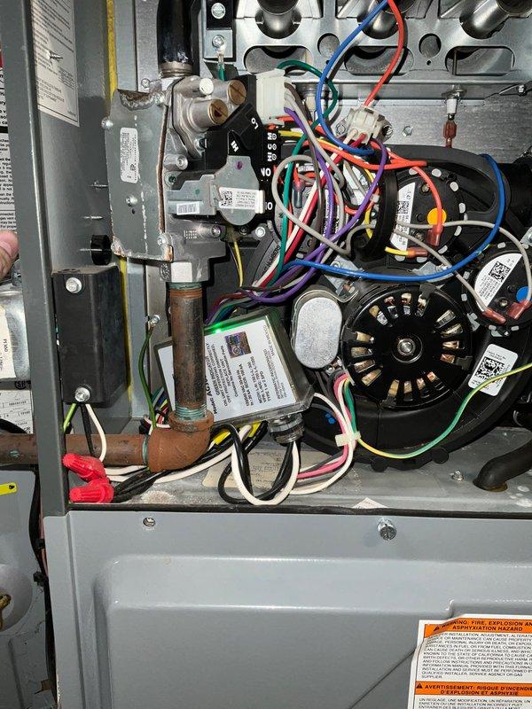 # HVAC Maintenance Service Report

Completed seasonal air conditioning tune-up on a 5-year-old residential cooling system as part of scheduled preventive maintenance agreement. Performed comprehensive inspection of outdoor condensing unit and indoor air handler components, verifying proper operation of dual blower motors, gas valve assembly, control board, and electrical connections. All wiring harnesses, terminal connections, and mechanical components were inspected and found to be in good working condition with no immediate repairs required. System documentation photographed for service records, and unit left in proper operating status for the cooling season.