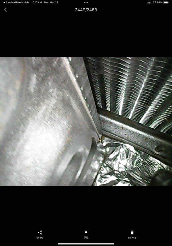 # HVAC Maintenance Service Summary

Completed routine Club AC10-2 preventive maintenance agreement visit on split air conditioning system. Performed comprehensive inspection of air handler unit interior and evaporator coil assembly. Interior compartment showed normal operational wear with accumulated dust and debris. Blower motor assembly inspected and found to be in serviceable condition. Noted vegetation debris present near outdoor opening requiring removal to prevent airflow restriction.

Inspected evaporator coil and found evidence of condensation on metal surfaces, indicating normal cooling operation. Coil fins displayed minor discoloration consistent with age but remain intact and functional. Observed moisture accumulation on interior panels, typical during cooling cycle operation. Insulation material at base of unit examined and remains in place. All components photographed for service records. System operational at time of departure.