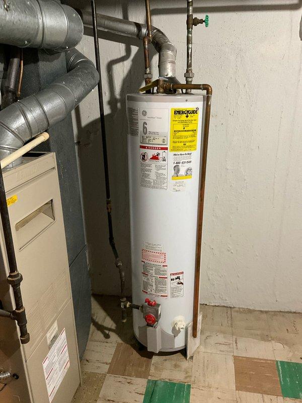 # Plumbing Estimate - Water Heater Replacement

Conducted on-site assessment for 40-gallon residential water heater replacement in basement utility room. Evaluated existing water heater installation, copper supply piping configuration, and venting requirements. Documented current plumbing connections including hot and cold water lines with shut-off valves, temperature and pressure relief valve discharge piping, and existing gas line routing. 

Inspected basement mechanical room layout and confirmed adequate clearances for new equipment installation. Noted existing water heater connections include copper supply lines with compression fittings, galvanized pipe sections, and multiple valve assemblies. Assessed condition of existing plumbing infrastructure and identified sections requiring replacement or modification during installation.

Prepared three separate quote options (03556-04, 03556-05, and 03556-08) for 40-gallon water heater replacement with varying specifications and installat