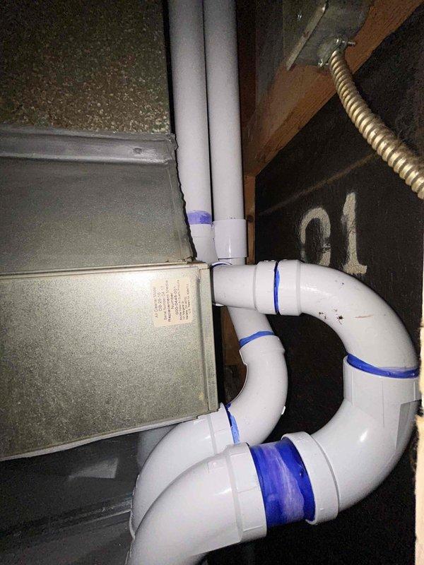 # HVAC Install - Furnace Service Summary

Completed installation of 70,000 BTU furnace and tankless water heater system in residential utility space. Successfully mounted tankless water heater unit to ceiling joists with proper copper supply line connections, brass shut-off valves, and PVC venting configuration routed through existing structure. Installed condensate drainage system using white PVC piping with serpentine routing to accommodate spatial constraints and ensure proper pitch for drainage. All mechanical connections secured and tested for proper operation prior to completion.