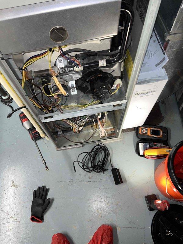 Completed preventive maintenance inspection on outdoor condensing unit and indoor air handler system as part of Club AC8-12 agreement. Performed comprehensive system evaluation including visual inspection of compressor motor assembly, fan blade operation, electrical connections, and refrigerant line integrity. Verified proper mounting and support bracket security on outdoor unit, inspected condenser coil fins for damage or debris accumulation, and confirmed adequate clearance around equipment. Conducted interior inspection of air handler with access panel removal, examining blower motor assembly, electrical wiring connections, and control board components. Tested system operation and measured electrical parameters using diagnostic meters to ensure equipment functioning within manufacturer specifications. All components found operating normally with no immediate service needs identified.