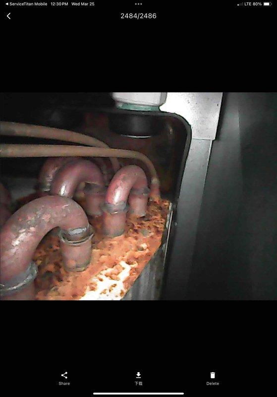 Completed annual AC maintenance and tune-up as part of membership agreement. Performed comprehensive system inspection revealing significant rust corrosion and sediment accumulation in condensate drain pan requiring attention. Inspected evaporator coil showing moisture condensation and dirt buildup on aluminum fins between vertical ridges. Documented system condition with photographic evidence of corrosion in drain pan and coil contamination for maintenance records.