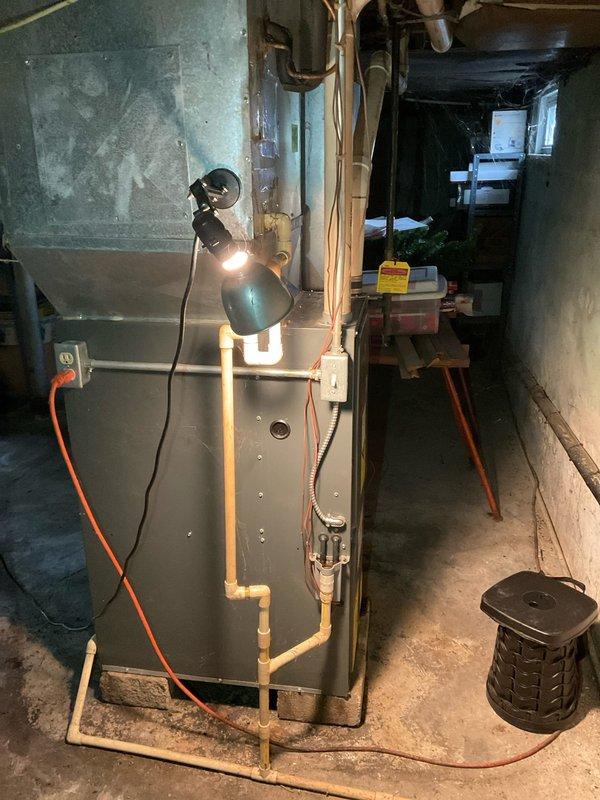Conducted on-site assessment of 20-year-old residential furnace with failed heat exchanger in basement mechanical room. Documented existing HVAC system configuration including gas connections, copper refrigerant lines, and ductwork arrangement. Prepared single component replacement estimate for furnace unit only, photographing current installation layout and equipment positioning to support replacement specifications.