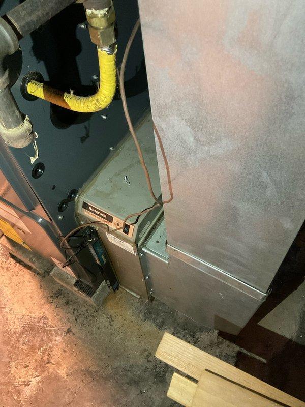 Conducted on-site assessment of 20-year-old residential furnace with failed heat exchanger in basement mechanical room. Documented existing HVAC system configuration including gas connections, copper refrigerant lines, and ductwork arrangement. Prepared single component replacement estimate for furnace unit only, photographing current installation layout and equipment positioning to support replacement specifications.
