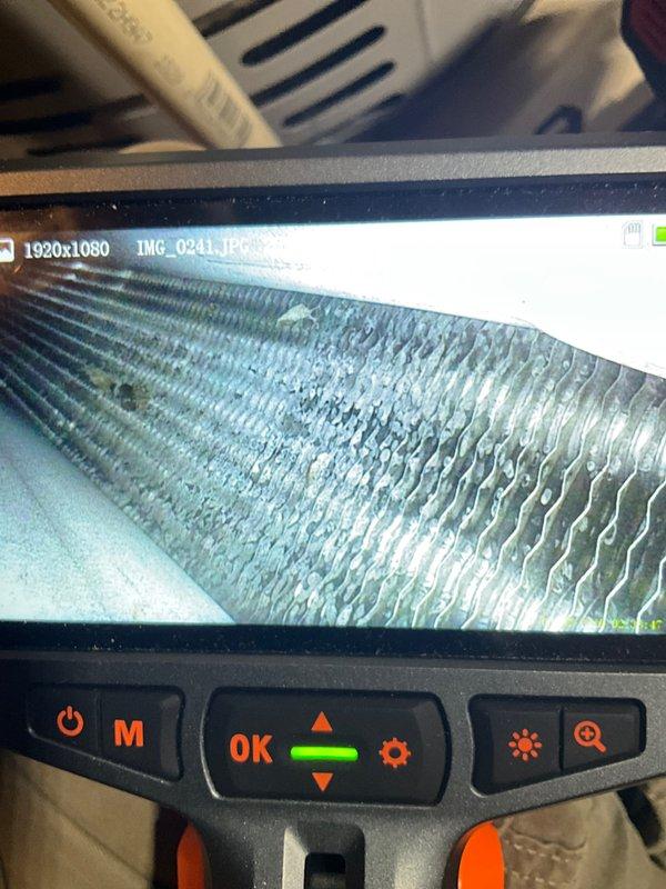 Completed preventive maintenance agreement visit on club AC12-4 system. Performed thorough inspection of air handler components, including removal and examination of blower wheel assembly. Blower wheel showed proper condition with clean, intact blades and hub. Utilized borescope camera to inspect evaporator coil, which revealed blue-green discoloration on fins indicating moisture exposure and possible oxidation or chemical deposits. Documented all findings with photographic evidence for service records. All mechanical components operating within normal parameters at time of inspection.