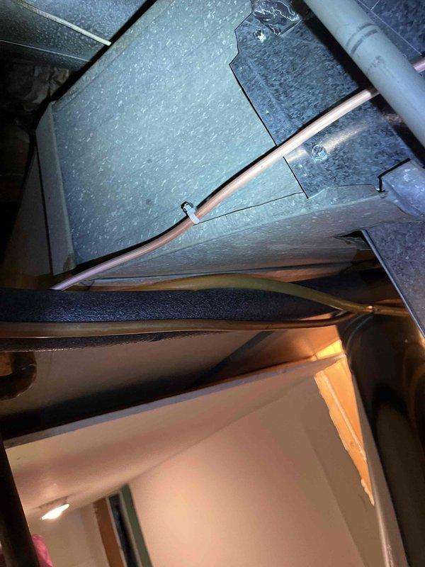 Responded to callback for reported refrigerant leak recurrence. Performed comprehensive system inspection and documented all components with photographs as requested. Inspected attic-mounted air handler unit, supply ductwork, and associated refrigerant lines. Examined condensate drain system including PVC drainage piping for proper operation. Verified all refrigerant line connections, joints, and fittings at the evaporator coil section. Checked electrical connections and control wiring for proper installation and secure terminations. Photographically documented ductwork installation, structural mounting, insulation integrity, and mechanical component configuration for service records. System inspection completed with full photographic documentation provided for review.