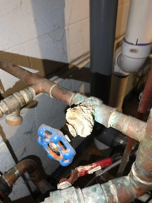 Responded to no-heat call for boiler system. Upon arrival after 3:30 PM, inspected unit and associated plumbing components. Found boiler not operating with visible corrosion on copper piping, deteriorated gate valve, and mineral deposits throughout system. Documented existing conditions including aged plumbing infrastructure, corroded fittings, and moisture accumulation in catch pan beneath equipment. System requires further evaluation and potential component replacement to restore proper operation.