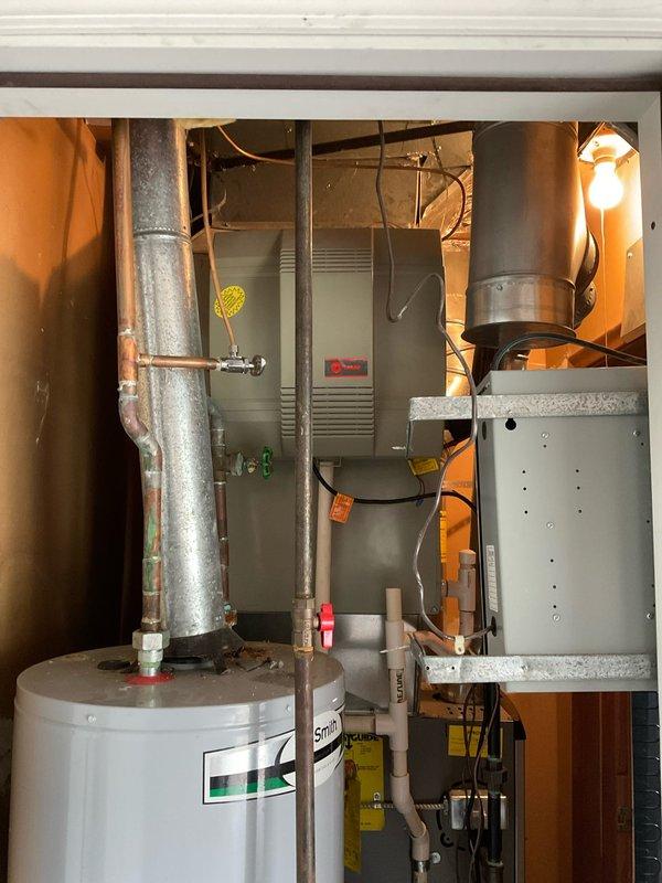 Performed comprehensive assessment of existing HVAC system with failed zone control panel. Evaluated 20-year-old air conditioning unit in conjunction with malfunctioning zone panel and documented current equipment condition through detailed photography of mechanical room components, including furnace, ductwork, water heater, and control board. Provided replacement estimate for complete air conditioning system, recommending full system replacement over repair due to age of existing equipment and cumulative repair costs.