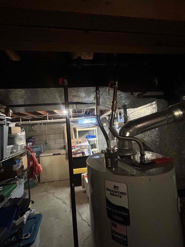 Responded to recall for water heater installation to address improper pressure relief valve discharge piping configuration. Upon inspection, installed compliant discharge tubing to pressure relief valve on Bradford White water heater per code requirements to complete permit correction. System verified operational with proper safety discharge piping now in place.