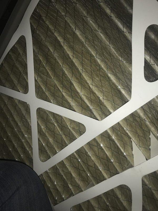 Completed club AC maintenance agreement visit for downstairs portion. Inspected and documented air filter condition showing pleated media with diagonal cross-hatch pattern and blower motor assembly with visible fan blades and shaft components. Both units operational with standard wear noted during seasonal inspection.