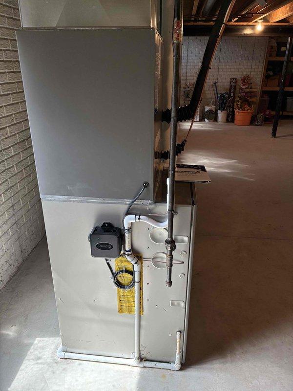 Completed installation of new air conditioning system and evaporator coil in residential basement location. System installed and integrated with existing furnace unit, with all ductwork connections properly sealed and secured. Financing documentation processed and approved, with required identification verified and maintained on file.