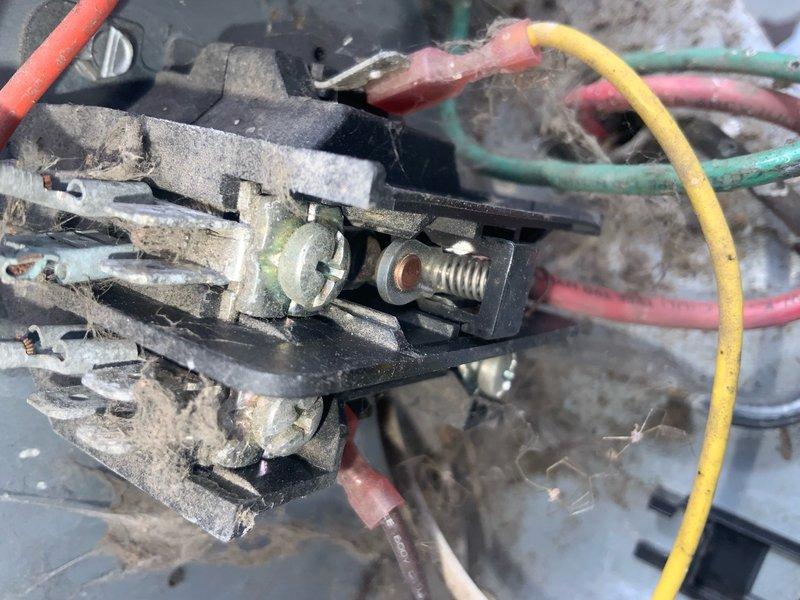 Responded to no-cool complaint on aging residential AC unit experiencing coil icing. Upon inspection, found heavily deteriorated electrical connections with significant dust accumulation, corroded terminals, and aged wire insulation on contactor assembly. Outdoor condensing unit showed signs of extended neglect with dirty internal components and compromised electrical connections that could restrict proper system operation and airflow, leading to evaporator coil freeze-up conditions.