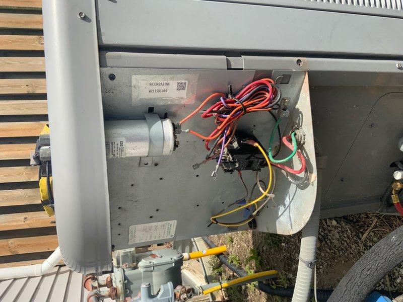 Responded to no-cool complaint on aging residential AC unit experiencing coil icing. Upon inspection, found heavily deteriorated electrical connections with significant dust accumulation, corroded terminals, and aged wire insulation on contactor assembly. Outdoor condensing unit showed signs of extended neglect with dirty internal components and compromised electrical connections that could restrict proper system operation and airflow, leading to evaporator coil freeze-up conditions.