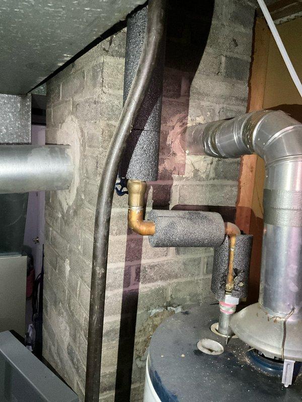 Conducted on-site evaluation and provided comprehensive quote for water heater replacement in residential basement utility area. Assessed existing white tank-style water heater installation, including venting configuration with metallic flue pipe, copper supply line connections, and insulated piping. Documented current equipment condition, plumbing connections, and existing infrastructure to determine replacement requirements and specifications for new unit installation.