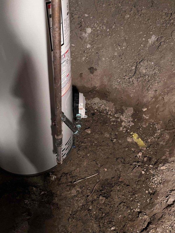 Completed installation of residential tanked water heater in crawl space area. Reconnected all water supply lines, gas connections, and exhaust piping to new unit, ensuring proper venting and secure mounting. System tested and verified operational with no leaks detected at connections.