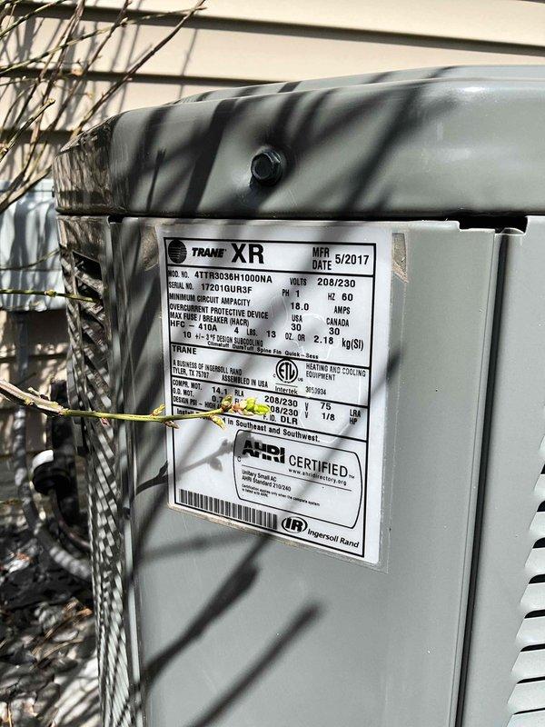 Completed preventative maintenance tune-up on Trane XR model 4TTR3036H1000AA outdoor condensing unit manufactured in May 2017. Performed comprehensive system inspection, verified proper operation of all components, cleaned condenser coils, checked refrigerant levels and electrical connections, and documented unit specifications and serial number for service records.