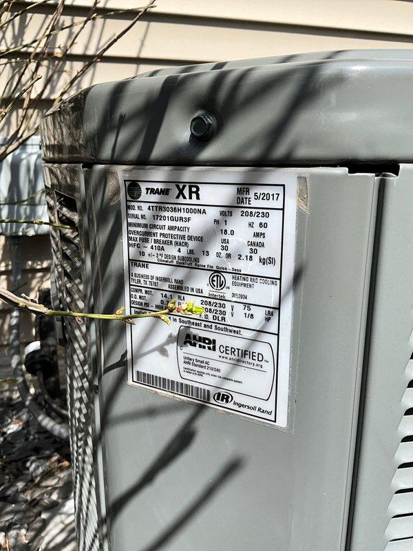Completed preventative maintenance tune-up on Trane XR model 4TTR3036H1000AA outdoor condensing unit manufactured in May 2017. Performed comprehensive system inspection, verified proper operation of all components, cleaned condenser coils, checked refrigerant levels and electrical connections, and documented unit specifications and serial number for service records.