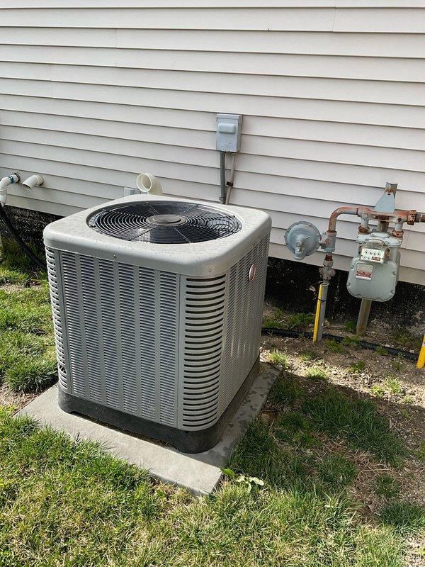 Conducted on-site evaluation for HVAC system replacement at residential property. Assessed existing outdoor condensing unit positioned on concrete pad adjacent to gas meter assembly, noting standard installation configuration with PVC condensate drainage lines. Evaluated indoor furnace unit in basement mechanical room, documenting current equipment specifications via digital control panel and existing service labels. Photographed both exterior and interior components to provide comprehensive documentation for replacement estimate preparation. Generated two separate quote options for system replacement consideration.