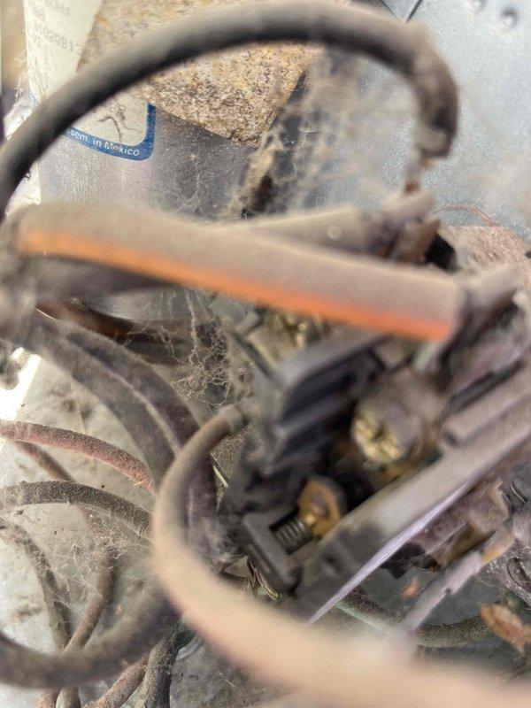 Completed comprehensive AC tune-up for returning homeowner requesting routine maintenance on cooling system of unknown age. Performed standard inspection of indoor evaporator coil assembly, noting accumulated dust and debris on white housing and mechanical components requiring cleaning attention. Inspected outdoor condensing unit connections, wiring, and electrical components at foundation level, observing weathered wiring and dust accumulation consistent with outdoor exposure. System operational upon completion of preventive maintenance procedures.