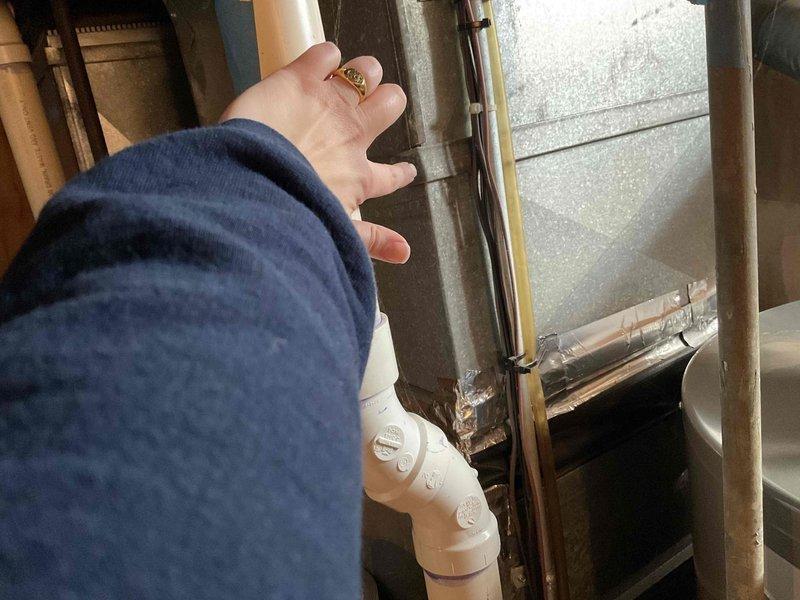 Conducted comprehensive assessment of existing 14-year-old HVAC system to provide replacement estimate. Inspected air handler unit, ductwork connections, and associated mechanical components in basement utility area. Documented current system configuration including metallic ductwork, insulated supply lines, PVC condensate drainage, and equipment placement within confined mechanical space. Photographed existing installation showing galvanized duct transitions, air handler positioning, and structural constraints for replacement planning purposes.