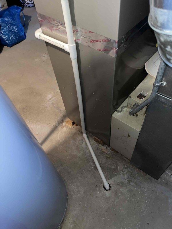 Completed Club AC10-2 preventive maintenance agreement visit on split system air conditioning unit. Upon inspection, discovered significant accumulation of organic debris, including pine needles and dried plant material, completely filling the evaporator coil drain pan and obstructing proper drainage pathways. Removed all debris from drain pan and verified drain line functionality to prevent potential water damage and system shutdown. Performed standard maintenance protocol including inspection of evaporator coils, condensate drainage system, PVC drain line connections, electrical components, and furnace unit. All system components operating within normal parameters following cleaning and inspection.