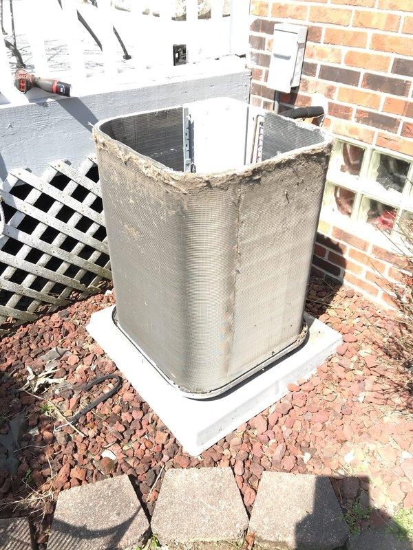 Completed scheduled maintenance agreement visit for residential air conditioning system. Performed comprehensive inspection of outdoor condenser unit, noting significant deterioration of protective mesh covering with frayed and compromised edges requiring future attention. Unit positioned on stable concrete pad with adequate clearance from structure. Verified proper installation on decorative rock landscaping base. Documented equipment condition through photographic evidence showing damaged mesh guard and overall system placement. System operational at time of inspection with no immediate service failures noted.