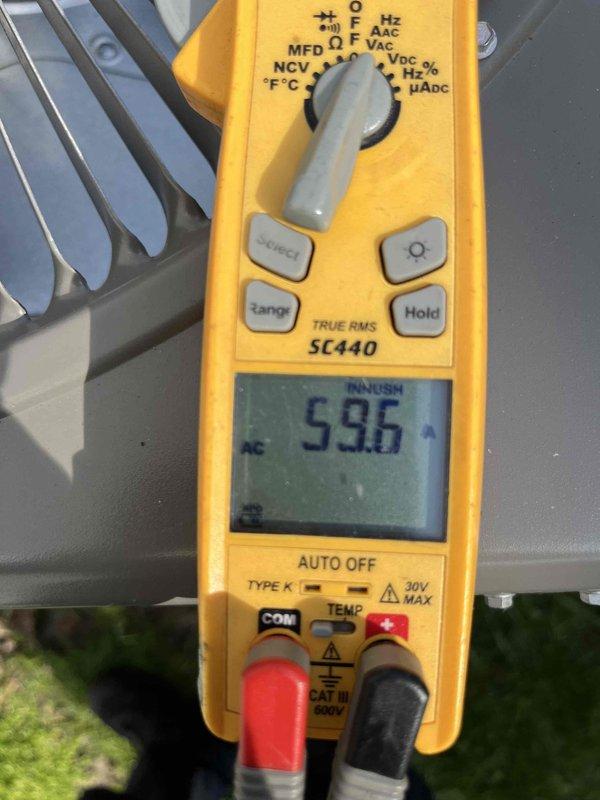 Completed scheduled AC tune-up maintenance visit as part of annual agreement. Performed comprehensive system inspection including electrical testing with multimeter, verifying line voltage at 59.5V and checking inrush current readings. Inspected condenser unit cabinet, heat sink components, and all accessible system panels for proper operation and condition.