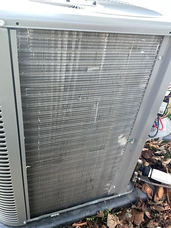 Completed annual AC maintenance tune-up as part of prepaid membership agreement. Performed comprehensive system inspection of outdoor condenser unit and indoor components, including examination of coil conditions, gas line connections, and electrical control systems. Documented equipment condition with photos showing condenser coils in operational status with normal outdoor weathering, properly assembled gas piping with code-compliant marking tape, and organized electrical wiring connections in control panel.