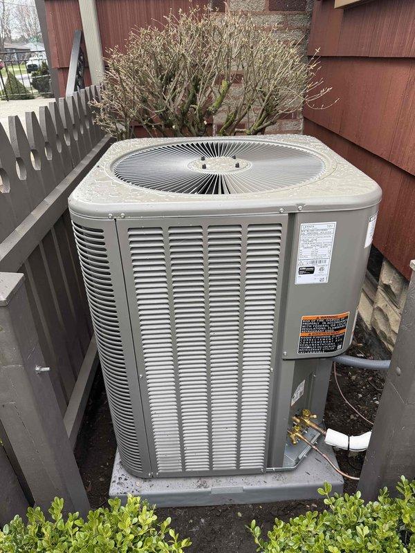 Completed installation of 2-ton Bryant air conditioning system including outdoor condenser unit and indoor evaporator coil. The outdoor condenser was positioned on a concrete pad adjacent to the deck area with proper clearances maintained, while the indoor air handler was installed in the basement utility area with PVC condensate drainage routed to ceiling connection. All mechanical connections, electrical wiring, and refrigerant lines were completed and the system was successfully reconnected and tested for proper operation.