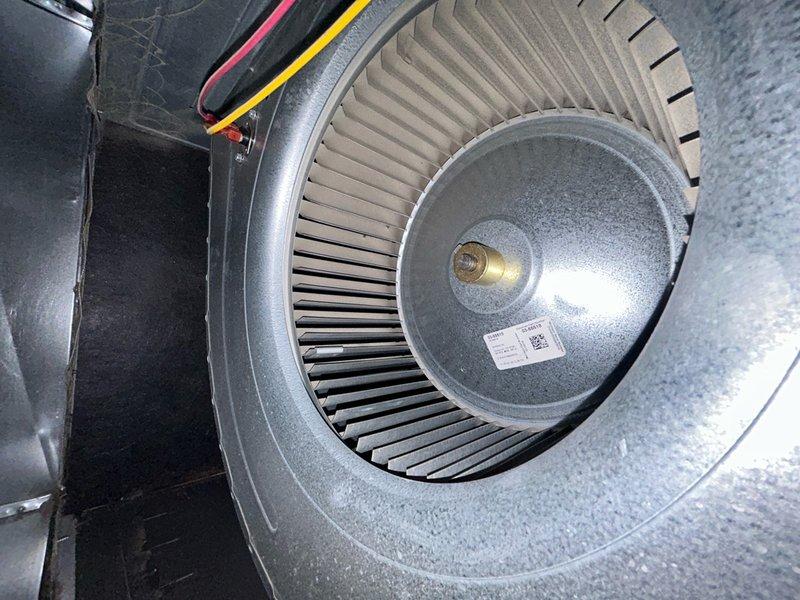 Completed preventative maintenance inspection under Club AC12-4 agreement. Inspected indoor air handler blower wheel assembly, confirmed squirrel cage fan operational with all radial fins intact and motor connections secure. Examined outdoor condensing unit and associated electrical components including power supply, terminal connections, and wiring harness. Noted debris accumulation in exterior equipment area and gutter system requiring routine cleaning to maintain proper drainage and equipment access.