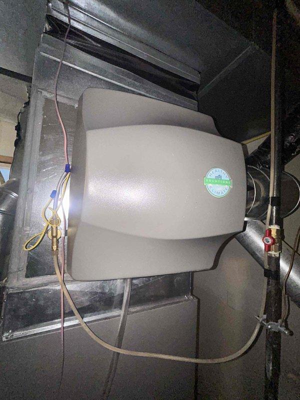 Responded to callback for non-operational air conditioning system and damaged humidifier access panel. Upon inspection, assessed HVAC ductwork and air handling equipment in attic space, identifying issues with system operation and sheet metal panel requiring repair or replacement at humidifier installation point. Completed necessary repairs to restore AC functionality and addressed humidifier panel deficiency using sheet metal materials to ensure proper system enclosure and operation.