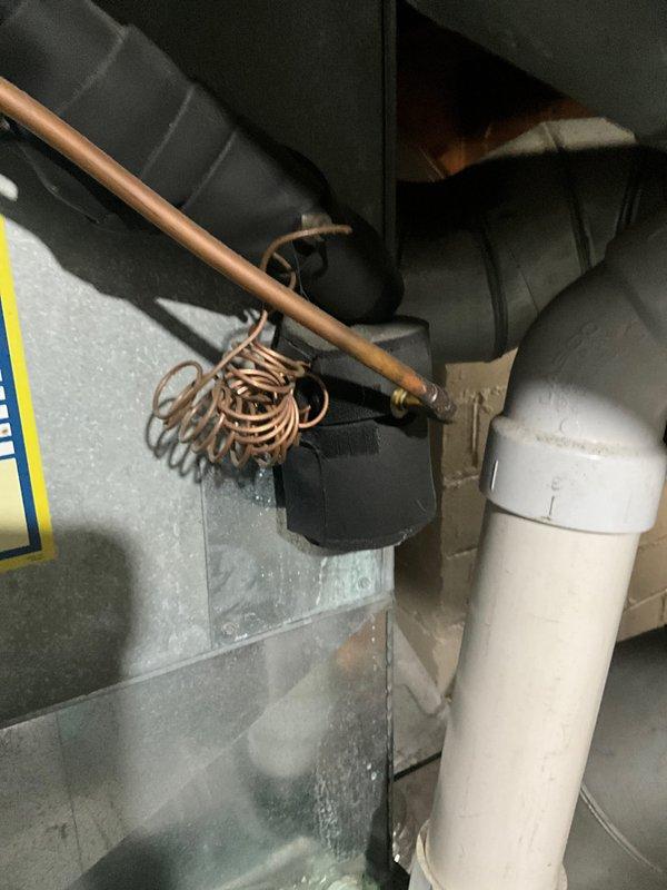 Completed routine maintenance agreement visit for residential air conditioning system. Inspected and documented condition of blower wheel assembly, which showed moderate dust and debris accumulation on blades and housing. Examined refrigerant lines, vibration dampener loop, and associated HVAC components in mechanical space, confirming proper installation and operational integrity of copper piping, condensate drainage system, and air handler connections.
