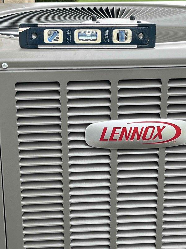 Completed prepaid AC maintenance tune-up on Lennox outdoor condensing unit. Performed comprehensive system inspection including verification of unit level, inspection of capacitor and electrical connections, and evaluation of condenser coil condition. All electrical components found secure with proper wire connections intact. Unit operating within normal parameters with no issues identified requiring immediate attention.