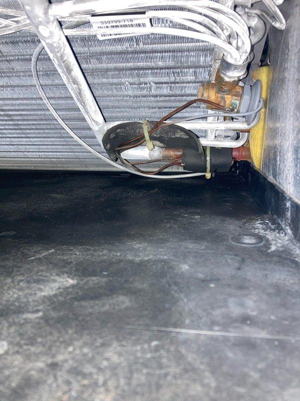 Completed routine maintenance inspection under Club AC8-12 agreement for residential air conditioning system. Performed comprehensive system evaluation including inspection of evaporator coil assembly, refrigerant lines, and electrical components. Evaporator coil showed normal operational condition with intact aluminum fins and proper insulation on refrigerant tubing. Verified brass valve connections and copper line integrity with no visible leaks detected. Inspected dual capacitors and associated electrical connections, confirming secure mounting and proper wire terminations. Noted moisture accumulation in drain pan, consistent with normal condensate collection during cooling operation. Replaced standard pleated air filter which showed moderate dust and debris accumulation, ensuring optimal airflow and system efficiency. All components operating within normal parameters with no immediate service needs identified.