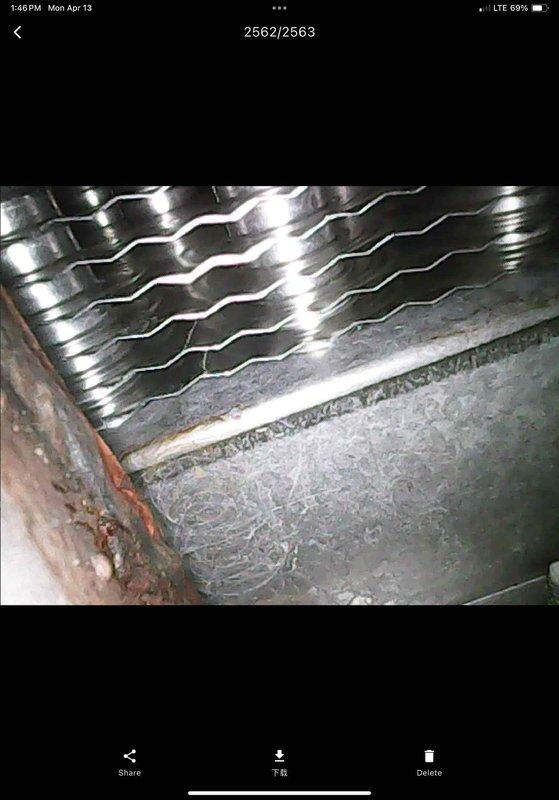 Completed annual maintenance visit on 19-year-old air conditioning and furnace system. Performed comprehensive AC tune-up including inspection of evaporator coils, which showed normal wear consistent with system age. Noted significant discoloration and debris accumulation in drain pan requiring monitoring for potential drainage issues. Inspected air handler interior components and documented rust staining around penetration points indicating possible moisture concerns. All systems operational at time of service. Photographed conditions for service records.