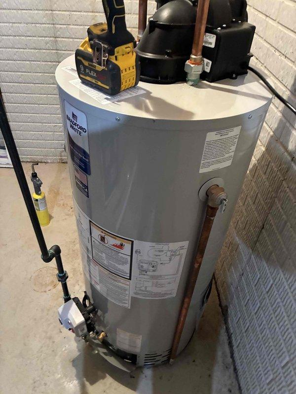 Installed new Bradford White tanked water heater in basement utility area. Connected all supply and discharge plumbing lines with copper piping, installed temperature and pressure relief valve with proper discharge piping, and verified all electrical connections to code. Unit tested and operational upon completion.