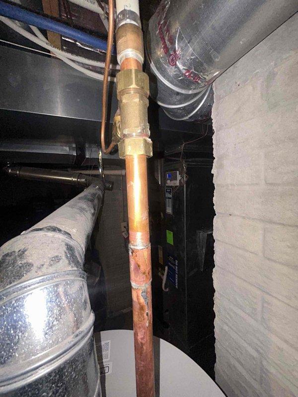# Water Heater Installation

Successfully completed installation of a new tanked water heater in the mechanical room. Installed copper supply piping with brass fittings and connectors to ensure proper hot and cold water connections. Routed all plumbing lines according to code requirements, securing pipes with appropriate brackets and supports. Verified proper venting configuration and clearances around the unit. Tested all connections for leaks, confirmed proper water flow, and ensured the system was fully operational upon completion.
