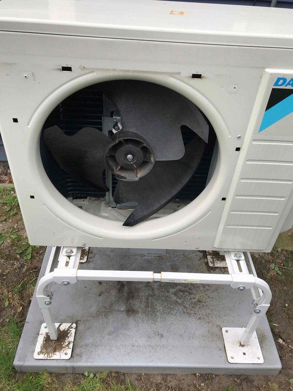 Completed prepaid AC maintenance tune-up on Daikin air conditioning system. Removed front panel to access condenser unit, inspected fan assembly and internal components for proper operation. Fan blades, motor housing, and mounting hardware showed normal wear with no mechanical issues detected. Cleaned exterior casing and mounting platform of accumulated dirt and debris. Verified all components functioning within normal parameters. Unit reassembled and returned to service.