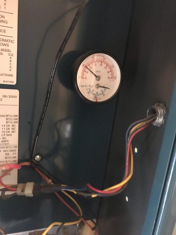 Responded to service call for reported boiler leak with significant dripping from piping. Upon inspection, identified severe corrosion on copper pipe fitting and joint connections near boiler assembly. Corrosion had compromised the integrity of the connection, causing active water leak. Documented existing conditions with photographs showing corroded copper components, pressure gauge readings, and overall boiler system configuration including specification plate indicating unit manufactured in June 2000. Performed annual maintenance inspection in conjunction with leak assessment. Examined all visible piping connections, flexible gas lines, valve assemblies, and corrugated stainless steel tubing throughout the system. Verified pressure readings on mounted gauge and inspected control wiring connections. Provided customer with documentation of corroded components requiring replacement and recommended immediate repair to prevent further water damage and potential system failure.