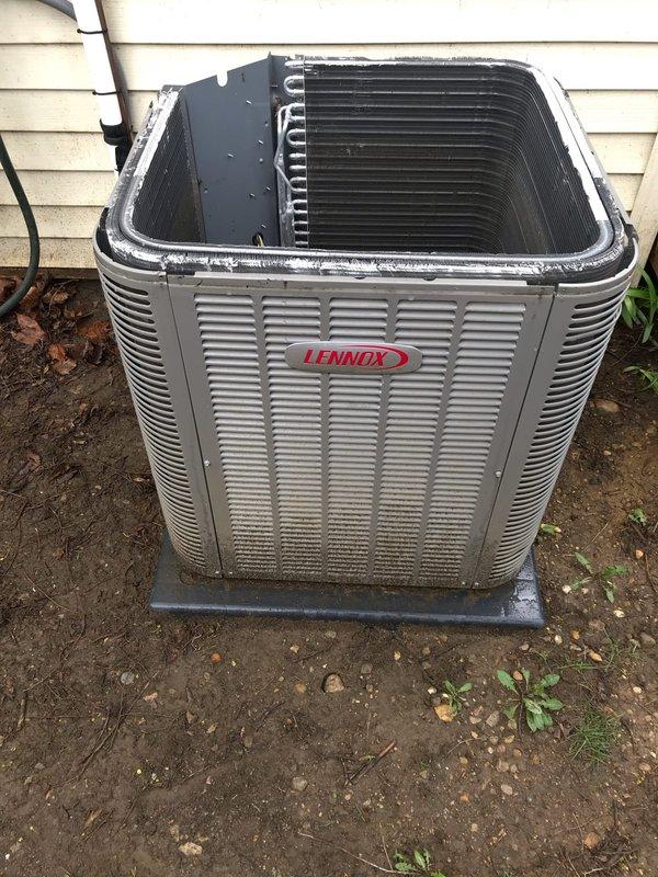 Completed scheduled AC maintenance visit on Lennox air conditioning system. Performed comprehensive tune-up including inspection of condenser unit, heat exchanger coils, compressor, and refrigerant lines. Noted significant rust and corrosion present in base pan around compressor mounting area with dirt accumulation. Condenser coils and fins found in acceptable operating condition with minor debris. All electrical connections inspected and copper refrigerant lines checked for proper operation. System currently functioning as designed despite cosmetic deterioration of base pan. Documented unit condition with photographs for maintenance records.