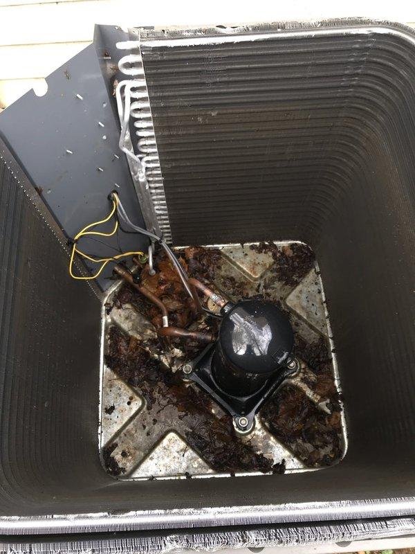Completed scheduled AC maintenance visit on Lennox air conditioning system. Performed comprehensive tune-up including inspection of condenser unit, heat exchanger coils, compressor, and refrigerant lines. Noted significant rust and corrosion present in base pan around compressor mounting area with dirt accumulation. Condenser coils and fins found in acceptable operating condition with minor debris. All electrical connections inspected and copper refrigerant lines checked for proper operation. System currently functioning as designed despite cosmetic deterioration of base pan. Documented unit condition with photographs for maintenance records.
